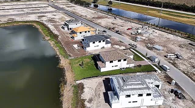Drone view of new homes going up beside a lake